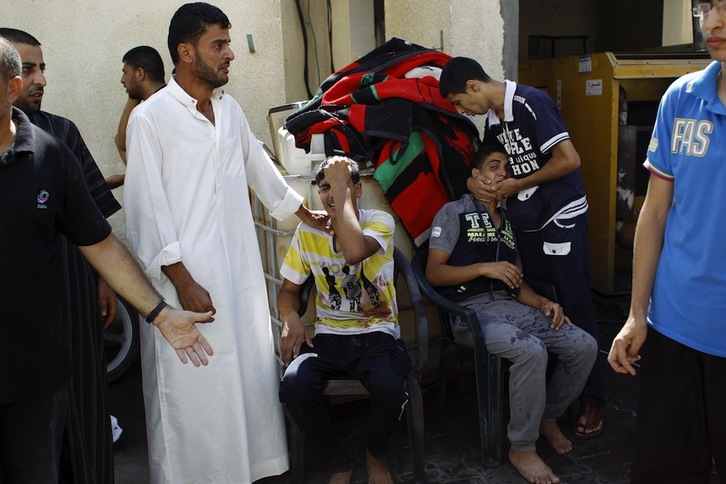 Varios palestinos lamentan la muerte de sus seres queridos en un ataque reciente. (Said KHATIB/AFP)