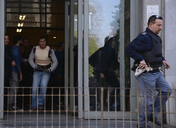 Dos policías salen del Palacio de Justicia de Milán, donde se ha producido el tiroteo. (Alberto PIZZOLI/AFP) 