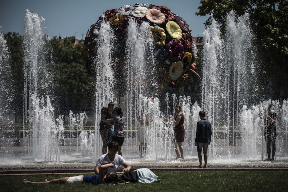 Niños juegan en una fuente pública de Lyon. (Jean-Phillipe KSIAZEK/AFP)