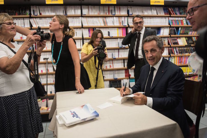 Sarkozy firma libros en un acto de su campaña para las primerias de la derecha, el pasado agosto. (DENIS CHARLET / AFP)