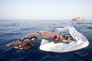 El rescate de la mujer superviviente por parte de un miembro de Open Arms. (Pau BARRENA / AFP)