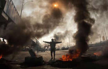 Un manifestante, en una carretera bloqueada en Basora (Hussein FALEH/AFP)