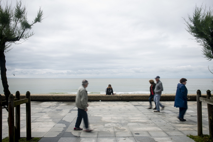 Personas de edad pasean cerca de la Grand Plage de Biarritz, que hoy a vuelto a abrirse al público. (Guillaume FAUVEAU)