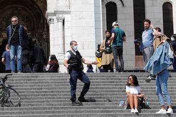 Un policía levanta a las personas sentadas en el centro de París. (Francois GUILLOT/ AFP)