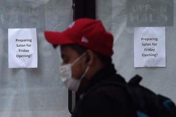 Un hombre pasa ante una peluquería que prepara su apertura en Arlington, Virginia. (Olivier DOULIERY/AFP)