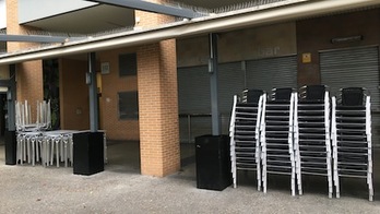 Mesas y sillas de terrazas recogidas en un establecimiento de hotelería cerrado por las nuevas medidas para contener el coronavirus.