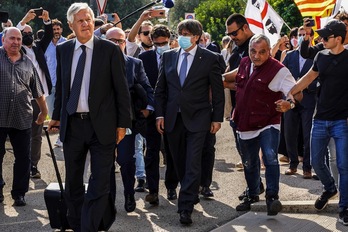 Carles Puigdemont, a su llegada al Tribunal de Apelación de Sassari entre banderas sardas y catalanas. (Gianni BIDDAU/AFP)