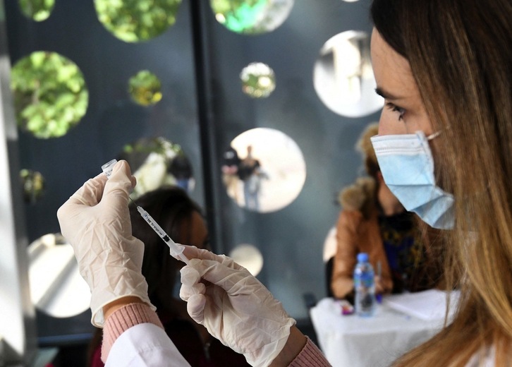 Erizain bat Sinovac txinatarraren txertoaren dosi bat prestatzen, Albanian. (Gent SHKULLAKU / AFP)