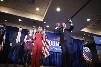 El republicano Glenn Youngkin lanza un balón firmado a un seguidor. (Anna MONEYMAKER/GETTY IMAGES/AFP)