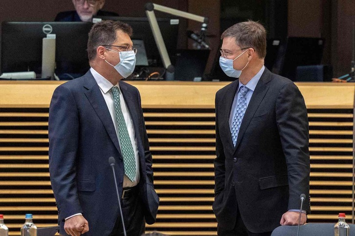 El responsable de Comercio, Valdis Dombrovskis, a la derecha, charla con el comisario Janez Lenarcic. (Olivier MATTHYS/AFP)