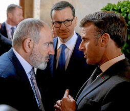 El primer ministro armenio departe indignado con el presidente francés.