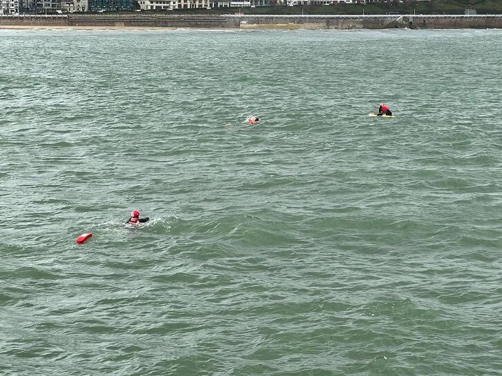 El nadador y los ertzainas rescatados en la Concha.