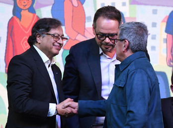 El presidente colombiano, Gustavo Petro, y Pablo Beltrán, del ELN, estrechan sus manos durante el acto en Bogotá. 