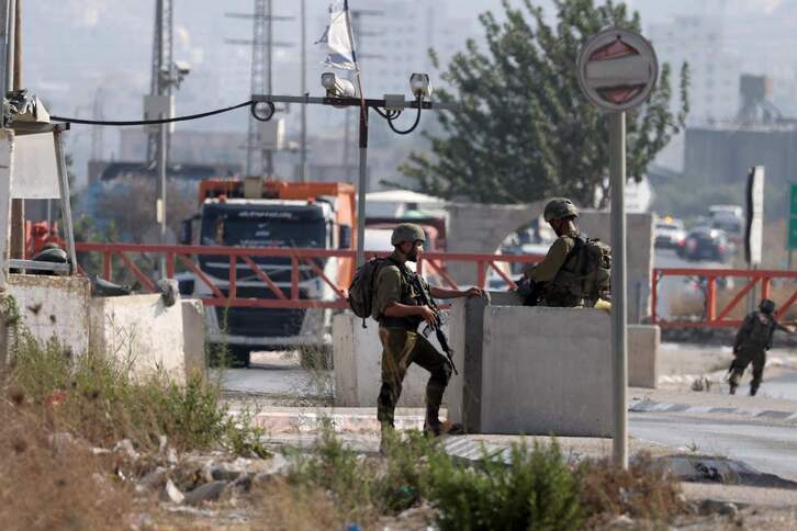 Fuerzas de seguridad israelíes montan guardia tras cerrar una carretera en Cisjordania.