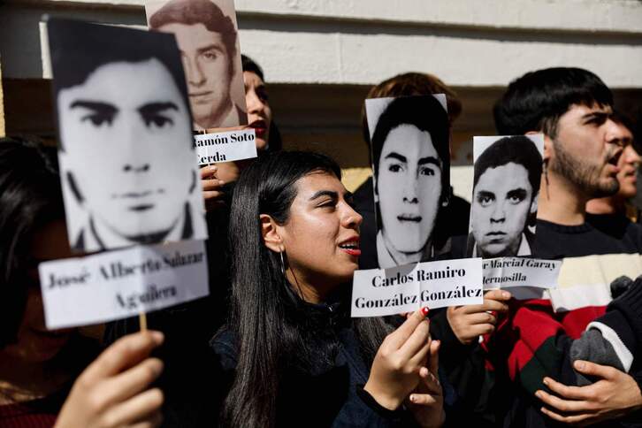 Estudiantes universitarios muestran fotos de personas desaparecidas durante la dictadura de Pinochet. 