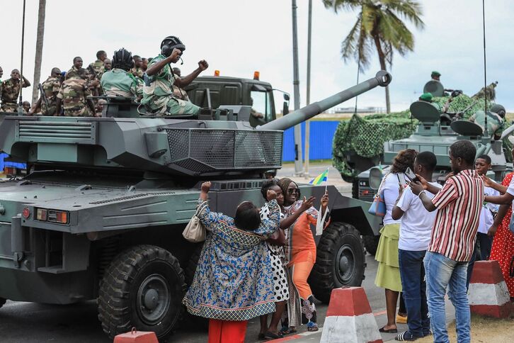 Ciudadanos se fotografían con uniformados tras la toma de posesión de Brice Oligui Nguema. 