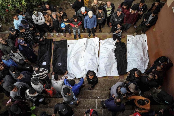 Gente rodea los cuerpos amortajados de sus seres queridos muertos durante el bombardeo israelí en el hospital Nasser en Khan Yunis.
