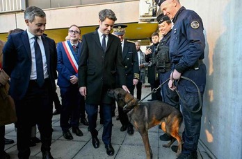 Gabriel Attal, acaricia a un perro policía durante su visita, junto al ministro de Interior, Gérald Darmanin, a una comisaría de la región parisina.