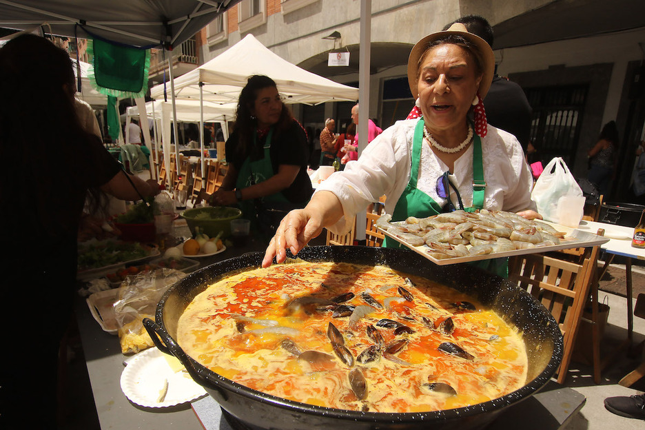 Una de las participantes añade ingredientes a su arroz.