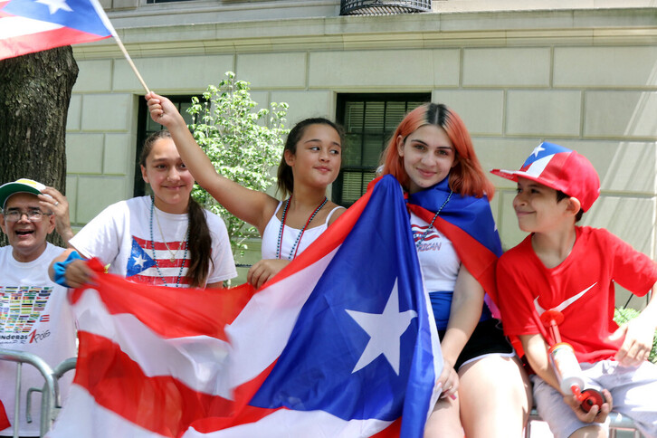 Unos jóvenes con banderas de Puerto Rico.