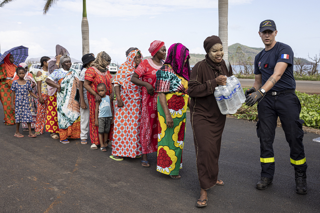 Un gendarme reparte agua en Mamoudzou, la ciudad principal de Mayotte.