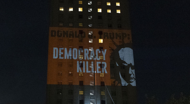 Un grupo de activistas proyecta en el edificio de los juzgados de Manhattan un mensaje llamando a Donald Trump «Asesino de la democracia».